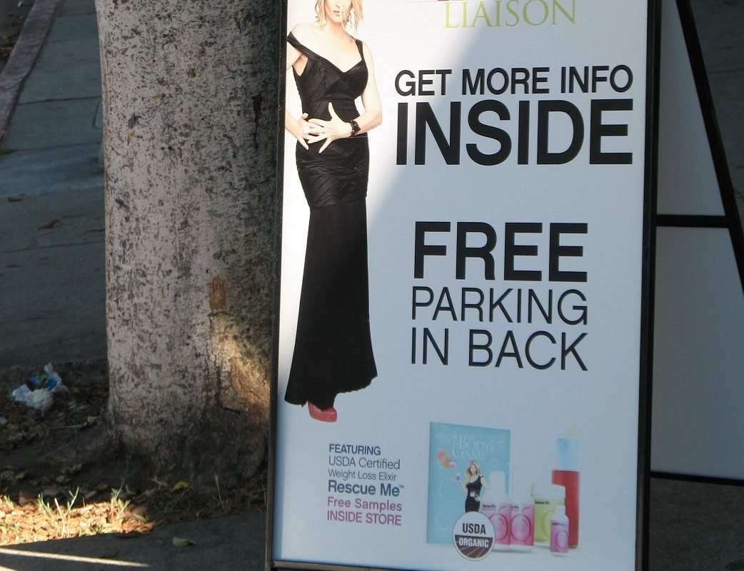 Kristie Alley in black dress on poster