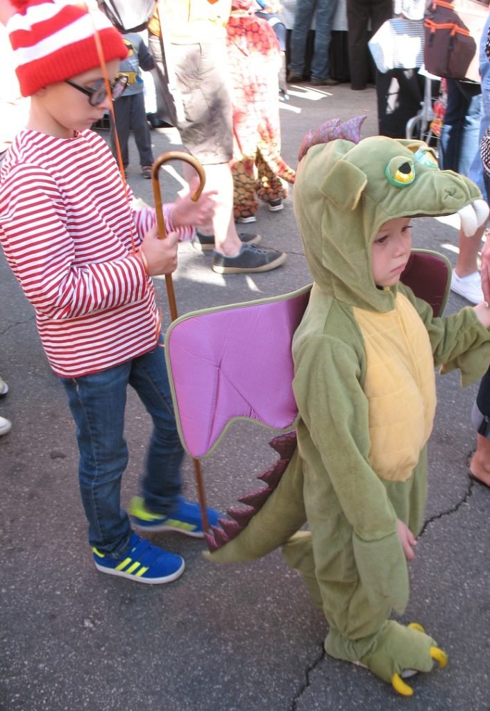 boy in green dinosaur costumer