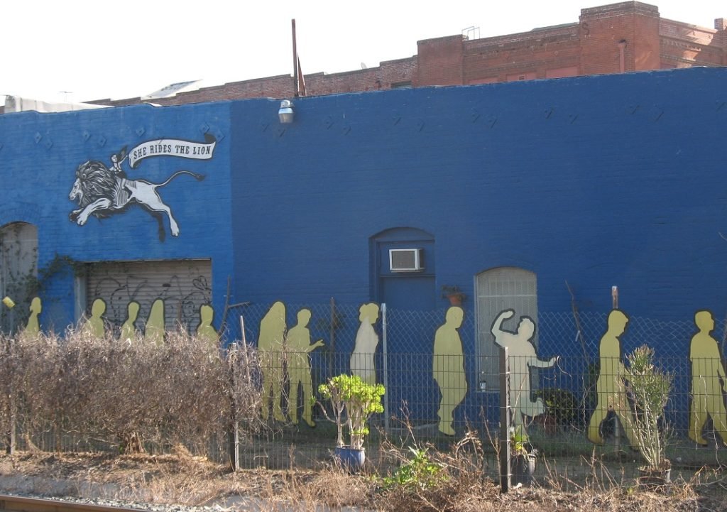 She rides the lion mural