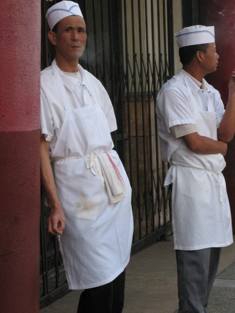 Two cooks on a break in Chinatown
