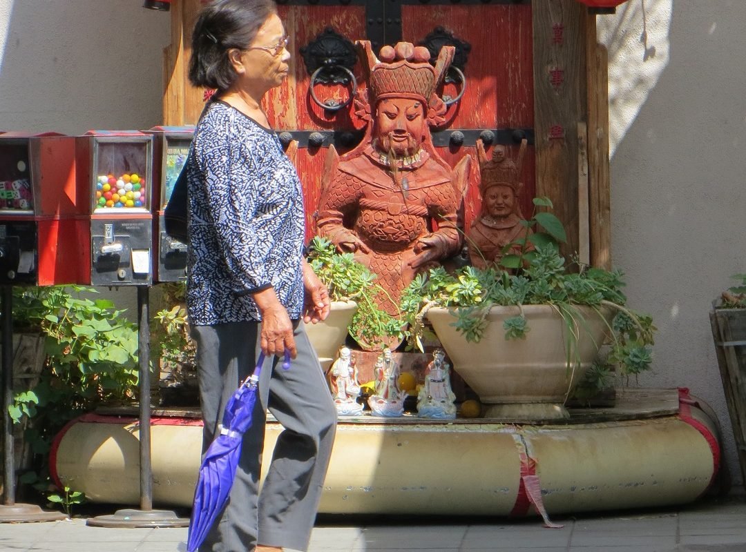 woman walking by shrine
