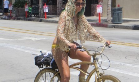 girl on gold bike with bikini and gold lace
