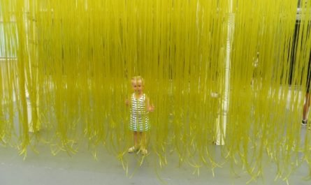 little girl in yellow hose sculpture
