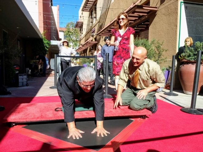 Luis Rodriguez,  L.A. poet laureate, puts handprints in Vroman’s Walk of Fame