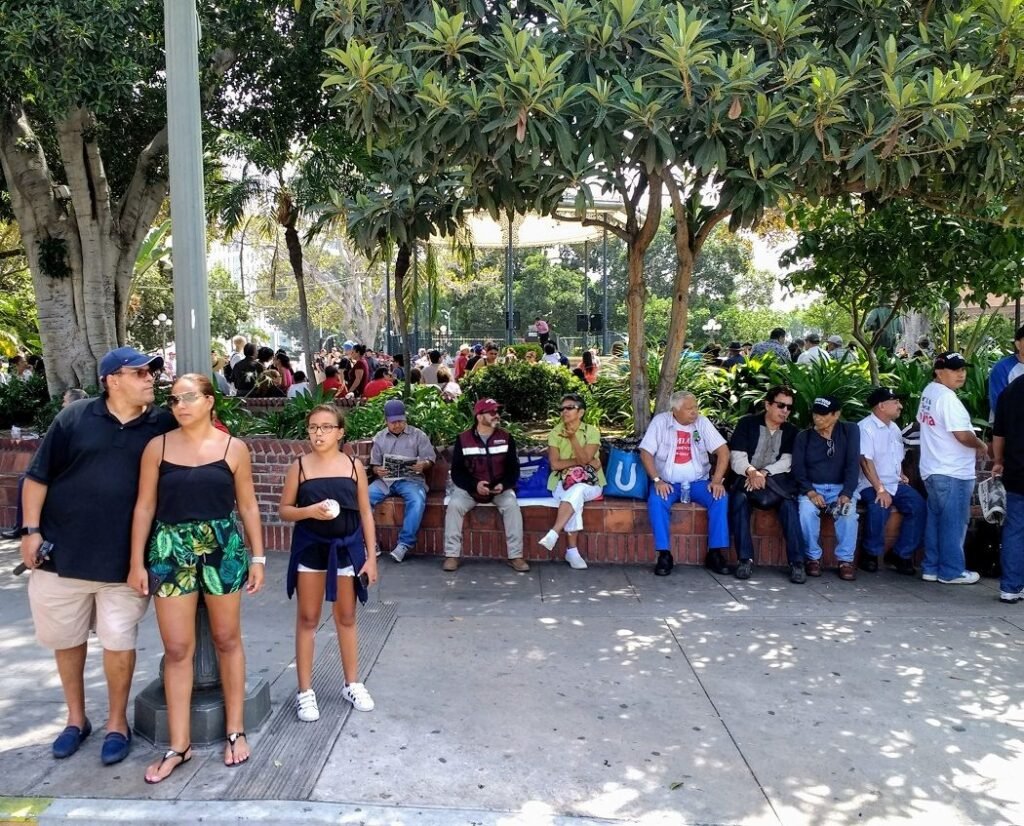 people sitting in Olvera Street plaza on Sunday afternoon